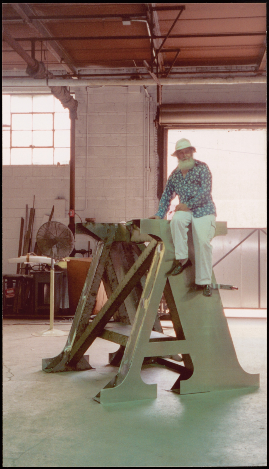 Indiana with a section of The Indiana Obelisk (2002), photographed while the sculpture is being fabricated at Milgo/Bufkin in Brooklyn, New York, 2001