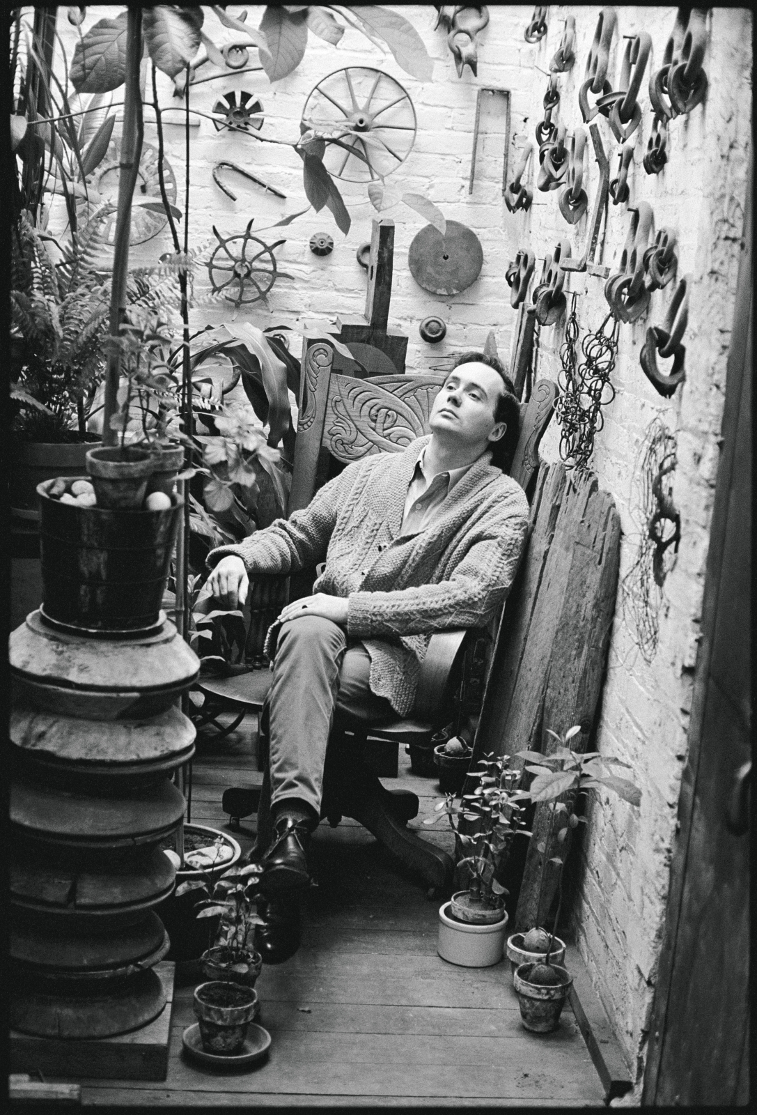 Robert Indiana sitting in the plant room at his Coenties Slip studio. Photo: &copy; William John Kennedy. Image courtesy of KIWI Arts Group