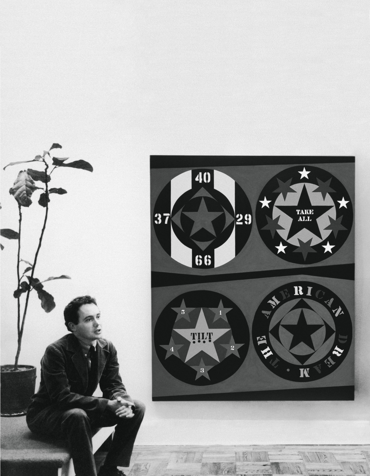 Robert Indiana with The American Dream, I&nbsp;(1960&ndash;61) at the David Anderson Gallery, New York, 1961.&nbsp;Photo: Hans Namuth/Posthumous digital reproduction from original negative/ Hans Namuth Archive, Center for Creative Photography &copy; 1991 Hans Namuth Estate