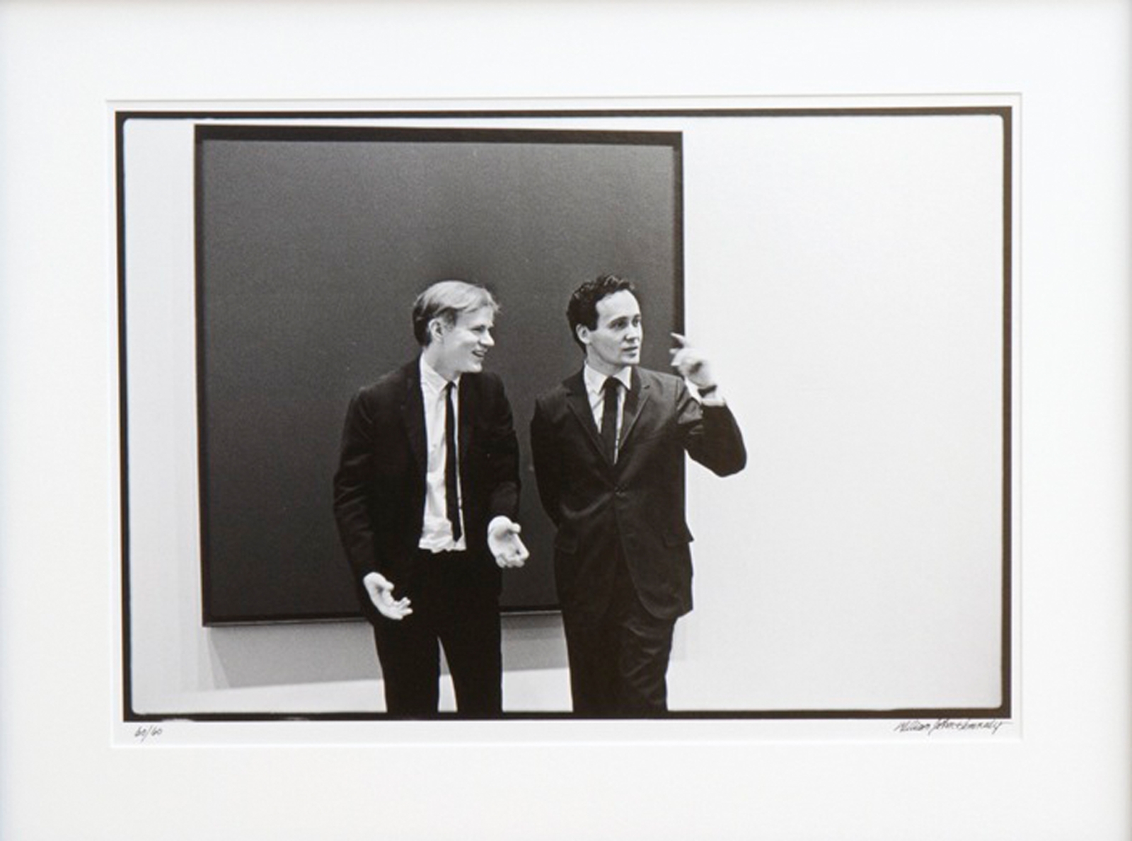 Andy Warhol and Indiana in front of an unidentified canvas by Ad Reinhardt at the opening of the exhibition Americans 1963 at the Museum of Modern Art, New York, May 21, 1963. Photo: &copy;William John Kennedy. Image courtesy of William John Kennedy/Kiwiartsgroup.com