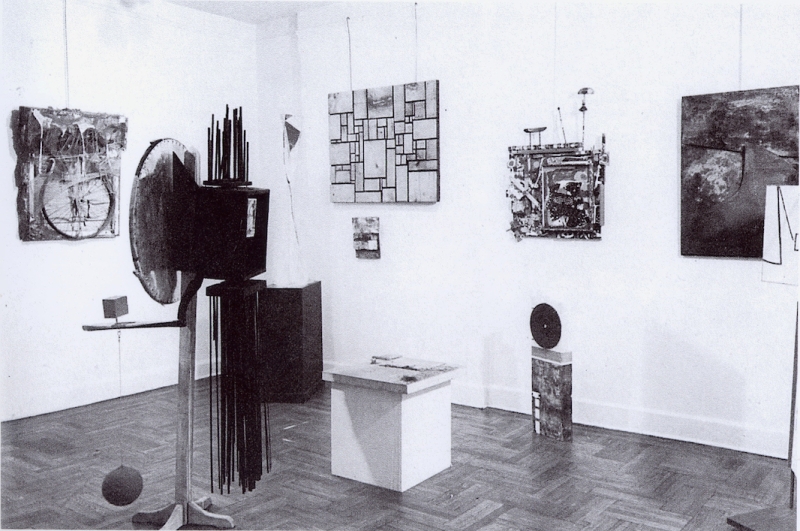 Installation view of the exhibition New Media—New Forms I at the Martha Jackson Gallery, New York, June 6–24, 1960, with Indiana’s sculpture French Atomic Bomb (1960) standing below the mid-sized canvas on the wall to the right
