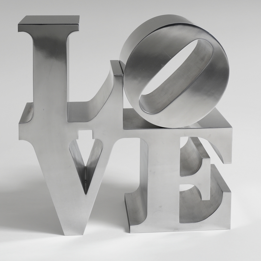 A 12 by 12 by 6 inch hand-cut and mirror-finished aluminum sculpture spelling love, consisting the letters L and a tilted letter O on top of the letters V and E. 