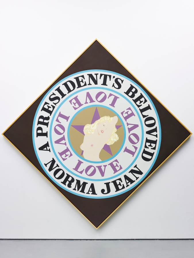 A President's Beloved is a 101 3/4 by 101 3/4 inch diamond shaped canvas with a black ground. A light brown circle surrounded by two white concentric rings with blue outlines dominates the canvas. In the center is an image of a topless Monroe against a purple star. The first ring contains the word Love painted in purple four times. The outer ring contains the text "A President's Beloved Norma Jean" painted in black.