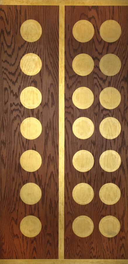 Three vertical rows of seven golden orbs against a plywood background. A gold vertical stripe separates the first row of orbs from the second two. A golden stipe has also been painted on the bottom and top edges of the plywood.