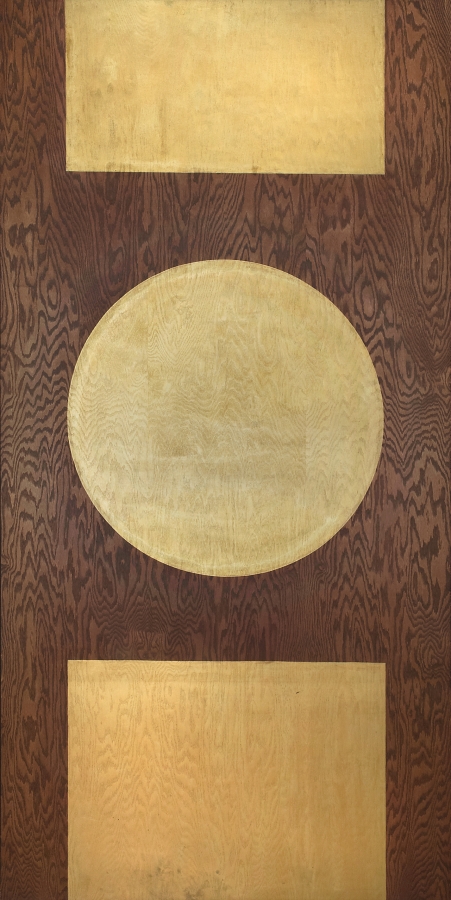 A large golden orb in the center of a plywood panel. Above and below the orb are two golden rectangles. The bottom rectangle is taller than the top one.