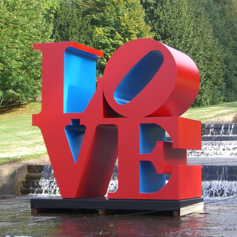 A 96 by 96 by 48 inch polychrome aluminum sculpture spelling love, consisting the letters L and a tilted letter O on top of the letters V and E. The outsides of the letters are the color red, and the insides are blue.